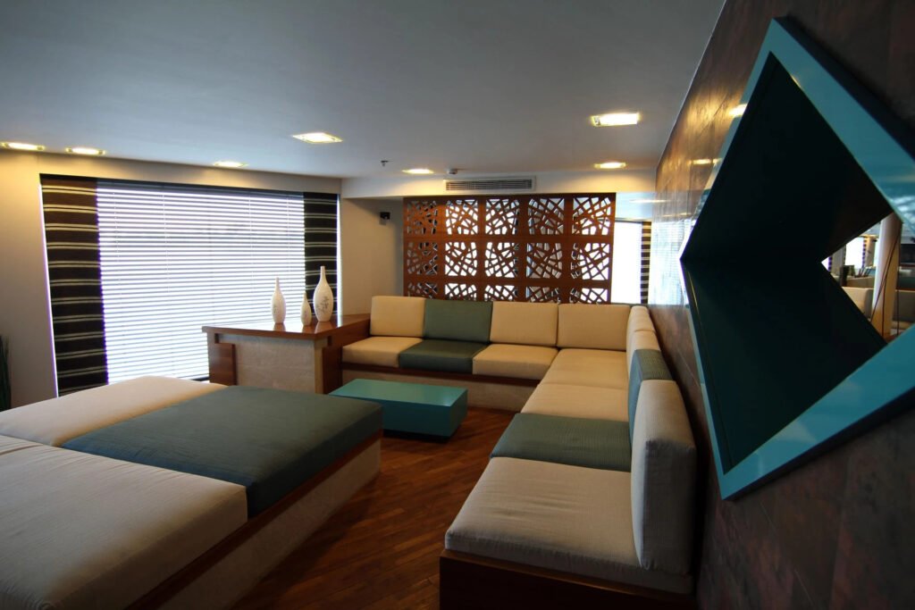 Modern living room with L-shaped sofa, decorative vases.